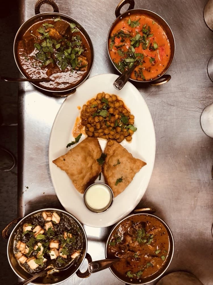 A full spread of curries, samosas and chana